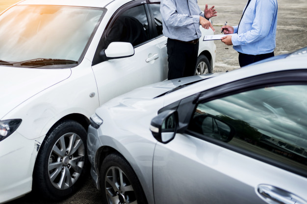 Insurance Agent Writing Clipboard While Examining Car After Accident 1423 1729, Entrust Insurance St. Clair Shores, MI and Southeast Michigan