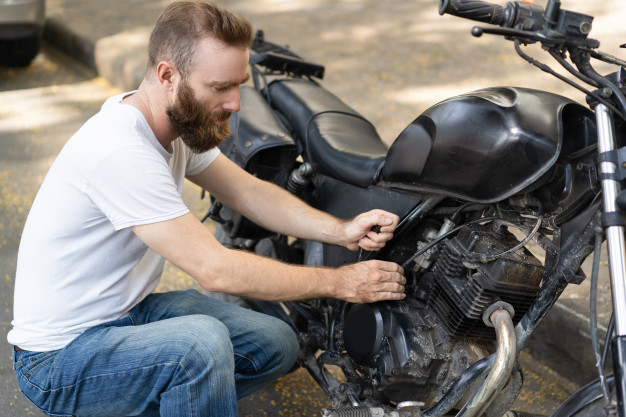 Focused Rider Trying Reanimate Broken Motorbike 1262 17366, Entrust Insurance St. Clair Shores, MI and Southeast Michigan