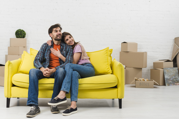 Loving Smiling Young Couple Sitting Yellow Sofa Their New House 23 2148095450, Entrust Insurance St. Clair Shores, MI and Southeast Michigan