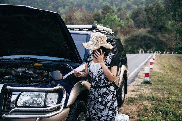 Asian Woman Calling Repairman Insurance Staff Fix Car Engine Problem Local Road 1150 10672, Entrust Insurance St. Clair Shores, MI and Southeast Michigan